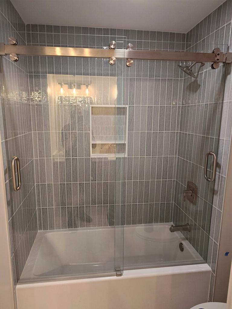 Frameless sliding shower enclosure installed in Marietta, GA.