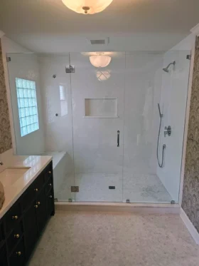 Three-piece inline frameless shower door with glass-to-glass hinges and chrome hardware in Atlanta, GA.